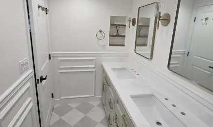 a builder applies yellow paint with a brush to wood